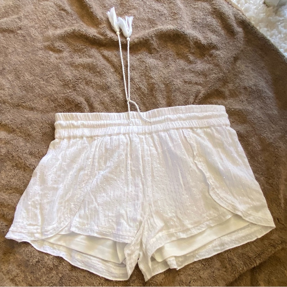 White shorts with silver embellishments. Used.